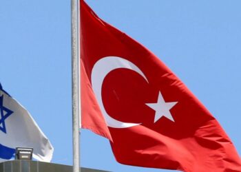 FILE PHOTO: A Turkish flag flutters atop the Turkish embassy as an Israeli flag is seen nearby, in Tel Aviv, Israel June 26, 2016.  REUTERS/Baz Ratner/File Photo