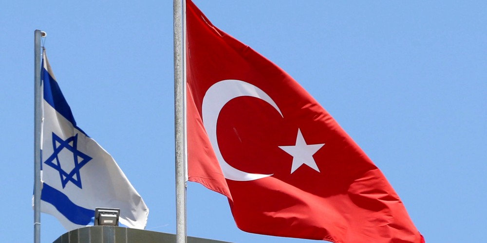 FILE PHOTO: A Turkish flag flutters atop the Turkish embassy as an Israeli flag is seen nearby, in Tel Aviv, Israel June 26, 2016.  REUTERS/Baz Ratner/File Photo