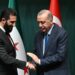 Turkish President Recep Tayyip Erdogan (R) and Syria's interim president Ahmed al-Sharaa shake hands during a joint press conference following their meeting at the Presidential Palace in Ankara, on February 4, 2025. Syria's interim president is in Turkey for talks with the country's leader after flying in from Saudi Arabia, where he was seeking help from wealthy Gulf countries to finance the reconstruction of his war-ravaged nation and revive its economy, as part of his second international trip since ousting the former Syrian president. (Photo by OZAN KOSE / AFP)