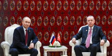 In this pool photograph distributed by the Russian state agency Sputnik, Russia's President Vladimir Putin and Turkish President Recep Tayyip Erdogan hold a meeting in Ashgabat on December 12, 2025. (Photo by Kristina Kormilitsyna / POOL / AFP)
