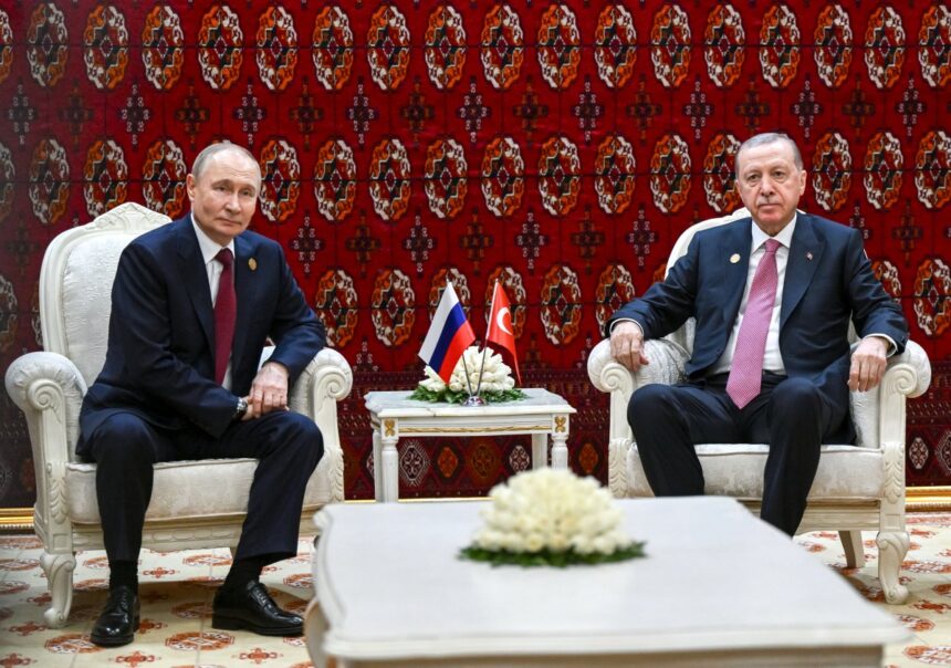 In this pool photograph distributed by the Russian state agency Sputnik, Russia's President Vladimir Putin and Turkish President Recep Tayyip Erdogan hold a meeting in Ashgabat on December 12, 2025. (Photo by Kristina Kormilitsyna / POOL / AFP)