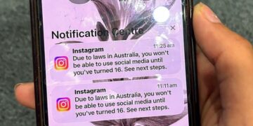 A teenager holds a mobile phone displaying a message from social media platform Instagram after the account was locked for age verification in Sydney on December 9, 2025. Australia will ban young teenagers from social media on December 10, 2025, launching a world-first crackdown designed to unglue children from addictive scrolling on the likes of Facebook, Instagram and TikTok. (Photo by AFP)