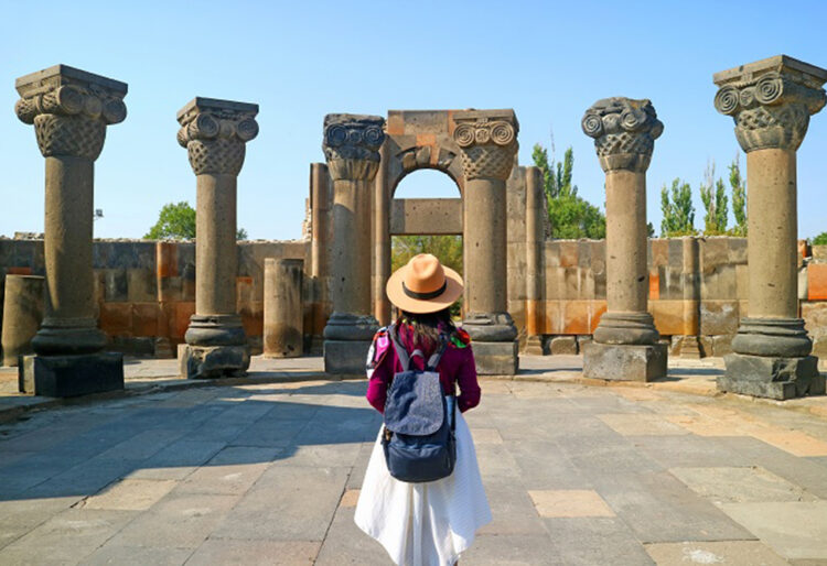 Female Traveler Visiting the Zvartnots Cathedral, UNESCO World Heritage Site in Armavir Province of Armenia