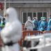 Passengers wearing a blue protective suits board a military bus after being evacuated from the Dutch flagged hantavirus-stricken cruise ship MV Hondius at the industrial port of Granadilla de Abona on the island of Tenerife in Spain's Canary Islands on May 10, 2026. Repatriation flights for the nearly 150 passengers onboard the ship hit by a deadly hantavirus outbreak began as passengers were transferred to shore on smaller vessels then by bus to the airport to be flown home after weeks at sea. (Photo by JORGE GUERRERO / AFP)