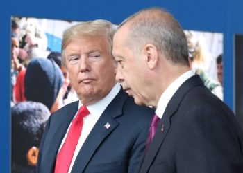 US President Donald Trump (L) talks to Turkeys President Recep Tayyip Erdogan (R) as they arrive for the NATO (North Atlantic Treaty Organization) summit, at the NATO headquarters in Brussels, on July 11, 2018. (Photo by Tatyana ZENKOVICH / POOL / AFP)