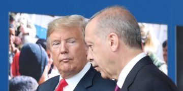 US President Donald Trump (L) talks to Turkeys President Recep Tayyip Erdogan (R) as they arrive for the NATO (North Atlantic Treaty Organization) summit, at the NATO headquarters in Brussels, on July 11, 2018. (Photo by Tatyana ZENKOVICH / POOL / AFP)