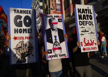 Protestors hold signs and wave flags during an anti-NATO demonstration in Istanbul, ahead of a NATO summit, on July 5, 2026. The next NATO summit will take place in Ankara on July 7-8 and is expected to be attended by 32 leaders including US President. (Photo by Yasin AKGUL / AFP)