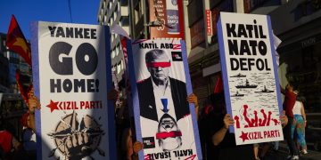 Protestors hold signs and wave flags during an anti-NATO demonstration in Istanbul, ahead of a NATO summit, on July 5, 2026. The next NATO summit will take place in Ankara on July 7-8 and is expected to be attended by 32 leaders including US President. (Photo by Yasin AKGUL / AFP)