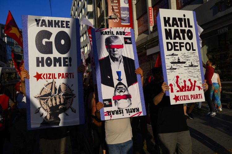 Protestors hold signs and wave flags during an anti-NATO demonstration in Istanbul, ahead of a NATO summit, on July 5, 2026. The next NATO summit will take place in Ankara on July 7-8 and is expected to be attended by 32 leaders including US President. (Photo by Yasin AKGUL / AFP)