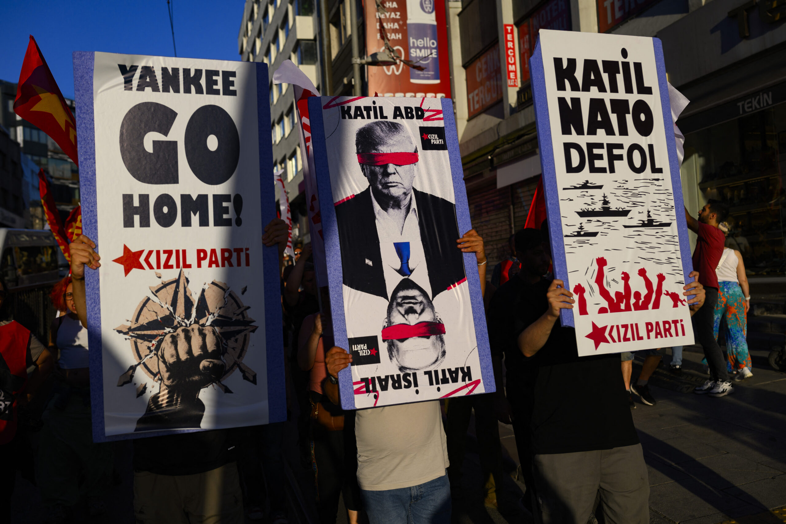 Protestors hold signs and wave flags during an anti-NATO demonstration in Istanbul, ahead of a NATO summit, on July 5, 2026. The next NATO summit will take place in Ankara on July 7-8 and is expected to be attended by 32 leaders including US President. (Photo by Yasin AKGUL / AFP)